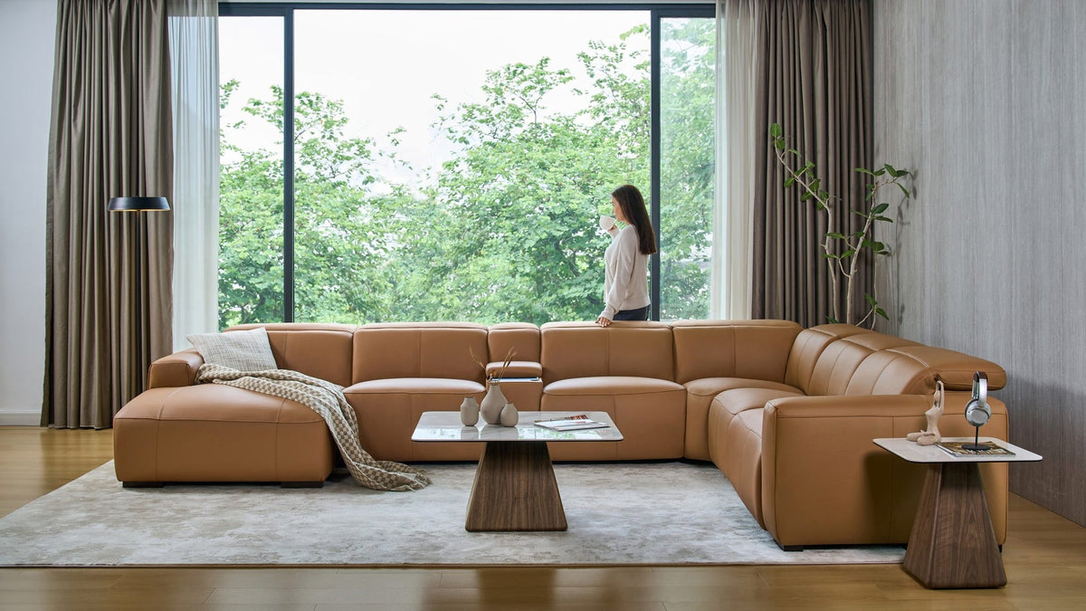 Jeddah U-shape corner sofa in tan leather with a timber-base coffee table in a light-filled living room